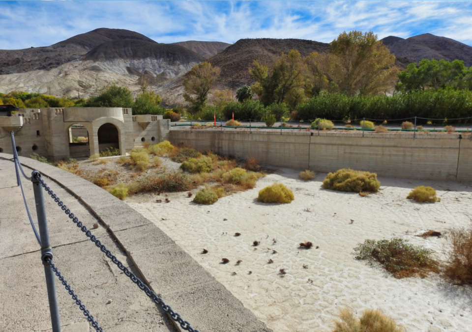 Large swimming pool filled with mud.