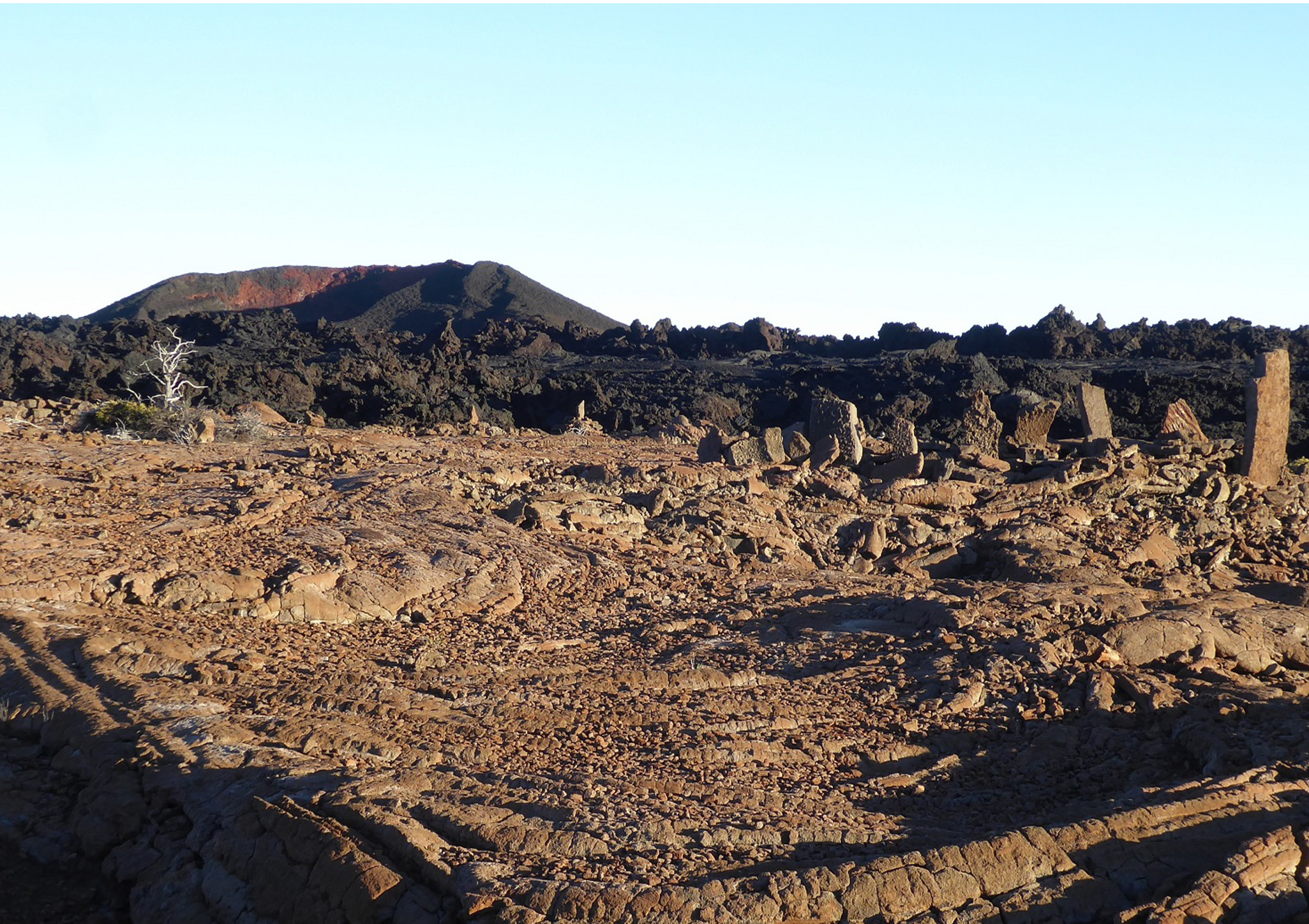 A black and white image of a cinder cone and stone altar.