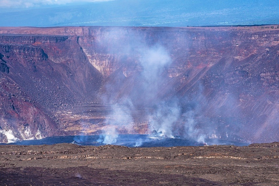 Crater filled with lava during the day.