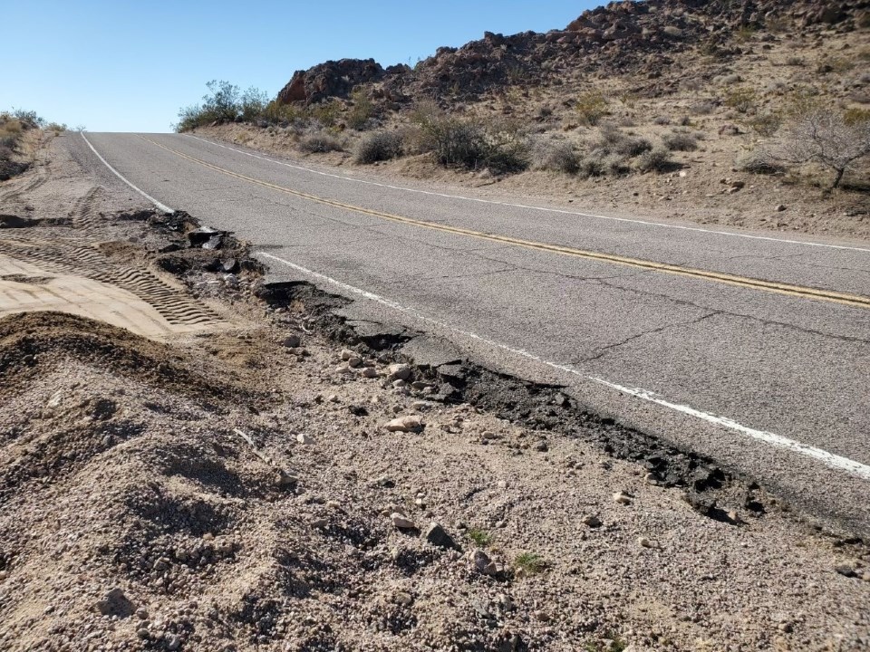 a desert road with a broken shoulder