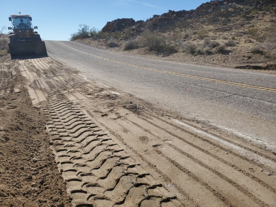 a desert road with a broken shoulder