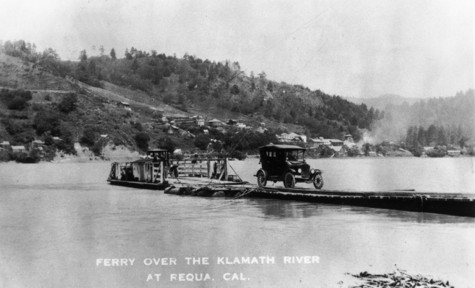 Old car on raft crossing river