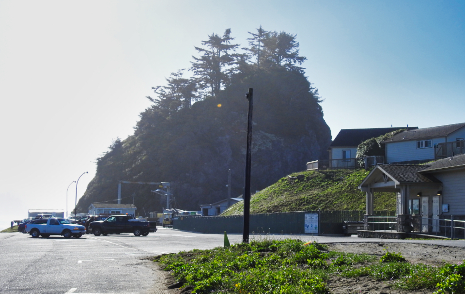 Train on tracks with hill behind and steam coming out