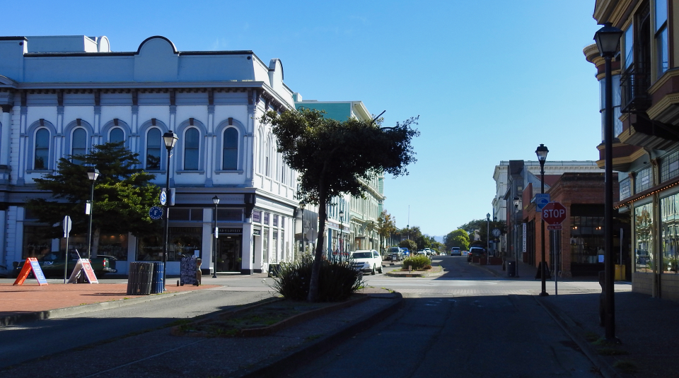 People standing on street with trolley car burning in background