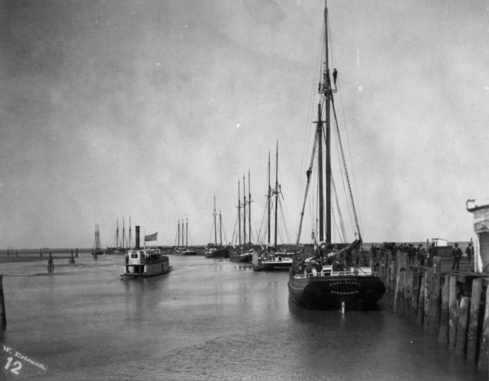 Old ships alongside a long wharf