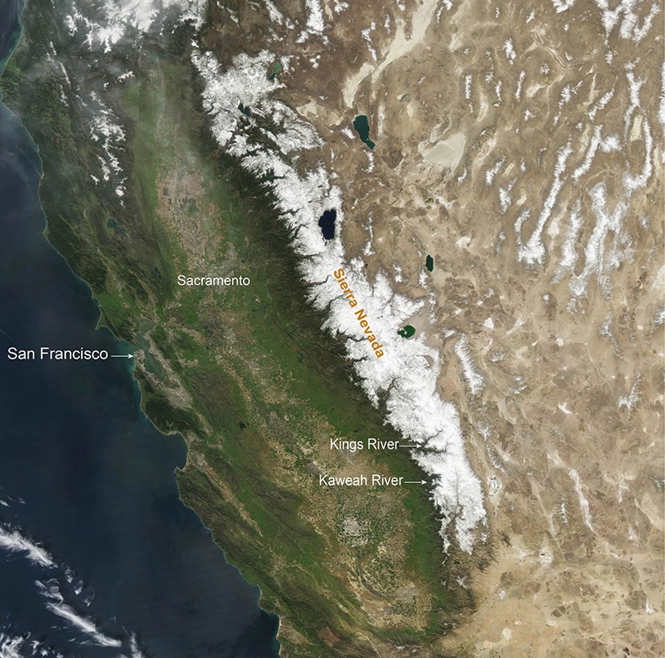 Aerial image shows view of an average year of snowpack (2010) in the Sierra Nevada, with snow covering middle to upper elevations across the Sierra Nevada.