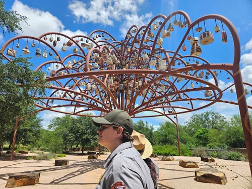 Photo of park ranger in front of art installation