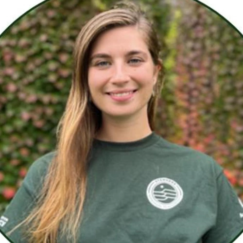 Portrait of a young woman wearing a dark green tshirt uniform