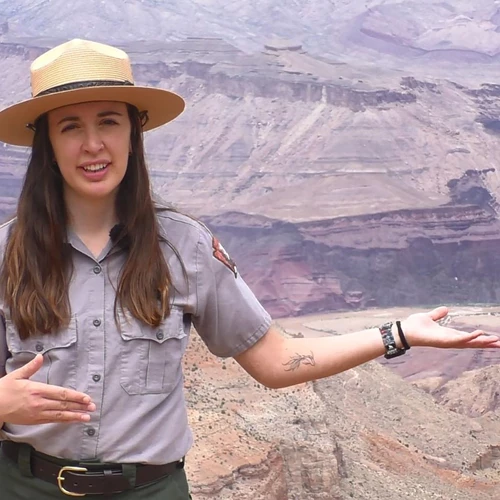 A ranger points to the Colorado River at the bottom of the Grand Canyon.