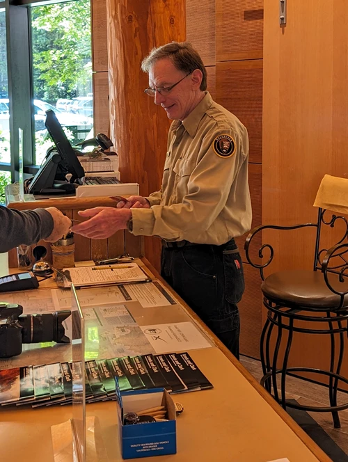 A Park Volunteer checks a national park pass