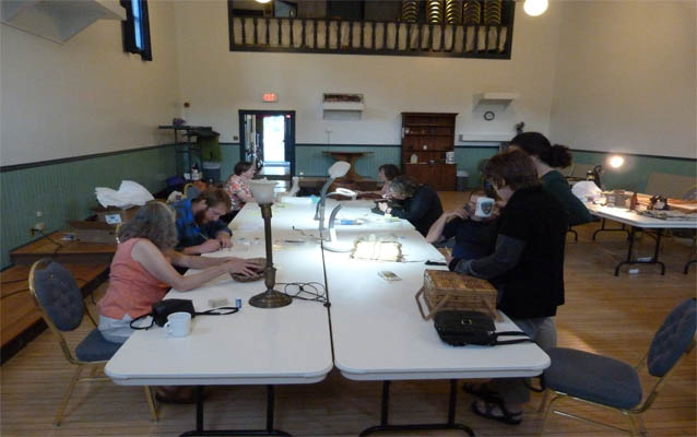 Group of people inspecting historic item