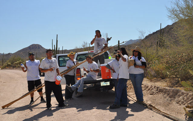 Youth Conservation Corps members relax at the pickup truck after a day of harvesting saguaro fruits