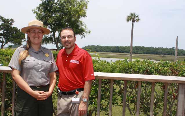ranger and partner in front of marsh