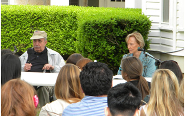 Harry Middleton and Bess Able seated in front of students