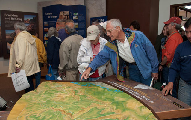 Visitors enjoying the new exhibits in Saddlehorn Visitor Center.