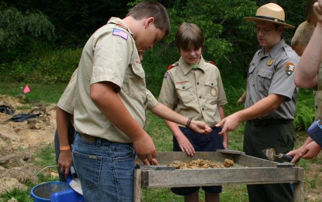 Boy Scouts and a Park Ranger looking for artifacts