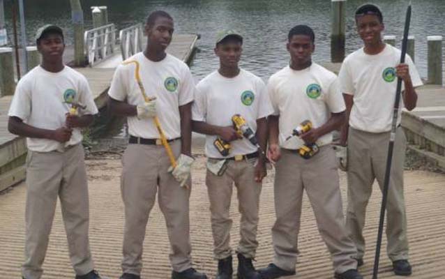 Five Chesapeake Youth Corps participants pose in front of the new universally accessible boat launch they helped build.