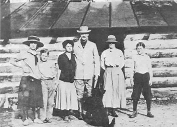 Levi Manning & family members In front of the cabin, circa 1906