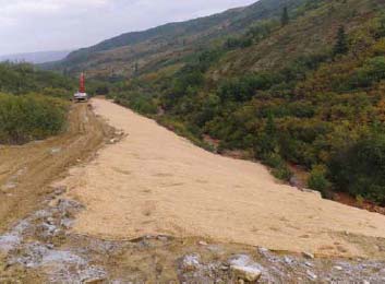 a wide, flattened dirt and gravel surface a wide, flattened dirt and gravel surface