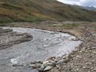 shallow creek flowing through a rocky valley