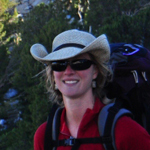 woman in a hat wearing a backpack