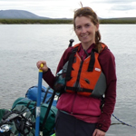 woman in a life jacket near a lake woman in a life jacket near a lake