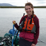 woman in a life jacket near a lake