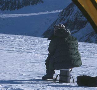 man sitting on a small plastic barrel