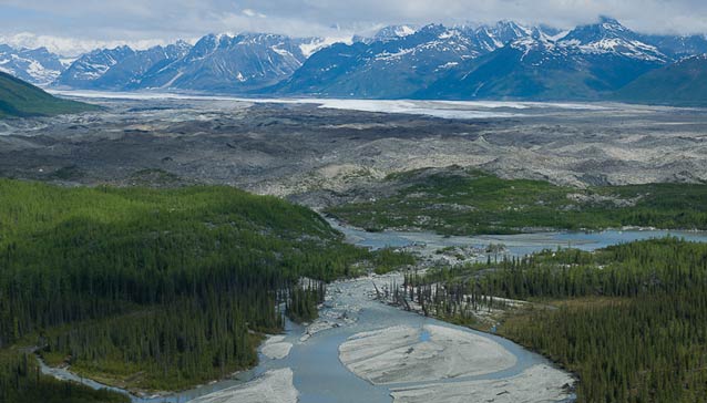 landscape with distant mountains and a river running through spruce forest landscape with distant mountains and a river running through spruce forest