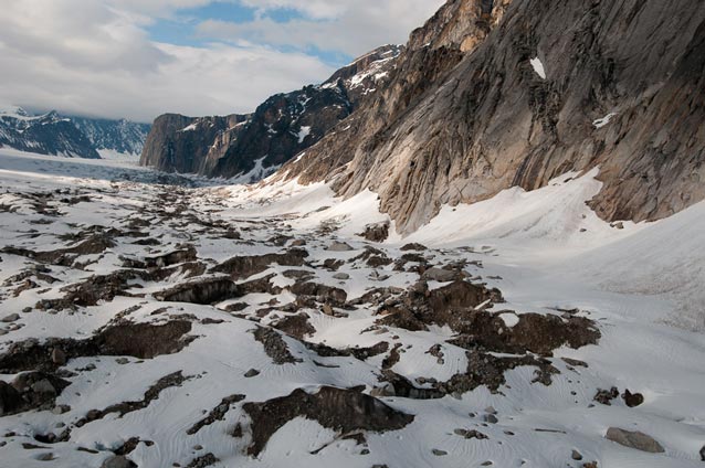 steep mountains with snow-covered rock debris at the base steep mountains with snow-covered rock debris at the base