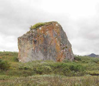 a huge rock in a field a huge rock in a field