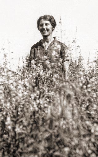 woman standing amid wildflowers