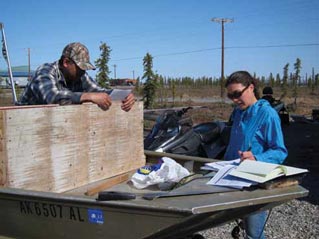 two people studying papers in an outdoor setting