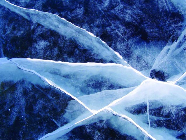 closeup of cracks in bluish ice closeup of cracks in bluish ice