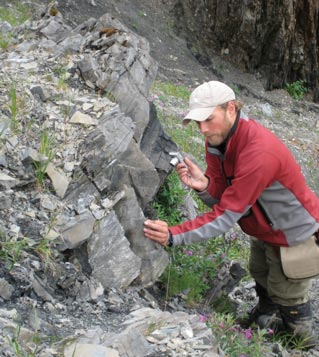 man looking at rocks