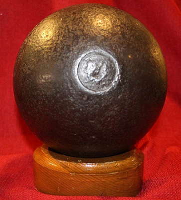 Cannonball sitting on wood stand