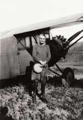 man standing next to a small plane man standing next to a small plane