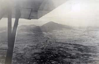 black and white view of a snowy, mountainous landscape