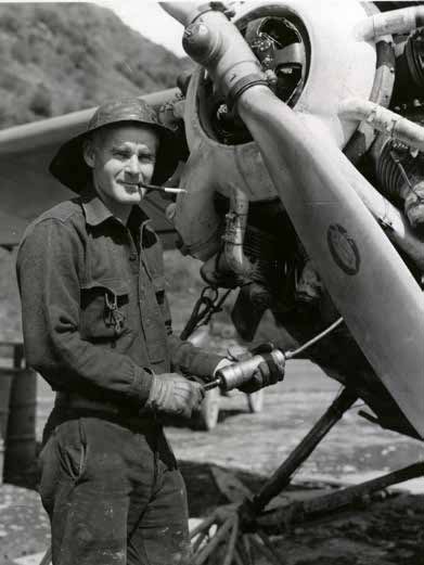 man standing nexts to the propeller of an airplane