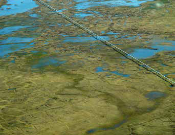 aerial view of a pipeline traveling across a landscape of bogs and lakes aerial view of a pipeline traveling across a landscape of bogs and lakes