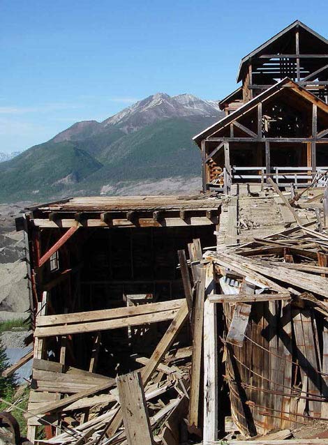 multi-story dilapidated wood building in a mountain setting multi-story dilapidated wood building in a mountain setting