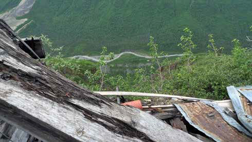 Looking downhill from the top of a sheet metal roof at a creek or narrow road Looking downhill from the top of a sheet metal roof at a creek or narrow road