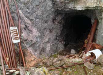 mine entrance cut into a rock wall mine entrance cut into a rock wall
