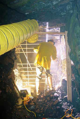 man in a tunnel welding a metal gate man in a tunnel welding a metal gate