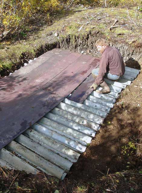 man sitting on a piece of sheet metal man sitting on a piece of sheet metal