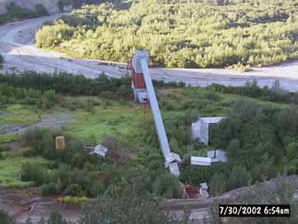 looking down at a series of mining buildings near a river