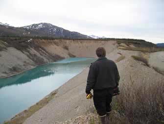 man standing near a rectangular pond man standing near a rectangular pond