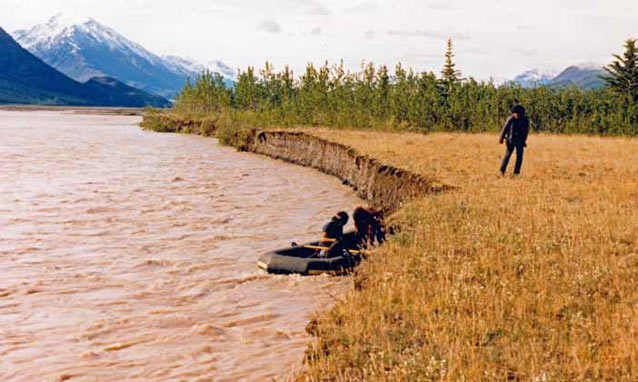 man standing near a river bank