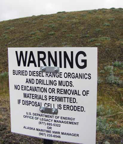 sign Warning buried diesel organics and drilling muds. no excavation or removal permitted