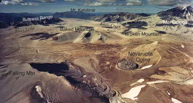 aerial view of a brown rocky mountainous landscape with various mountains named